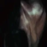 Dark silhouette footage of a live drum set at 0:07