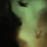 Dark silhouette footage of a live drum set at 0:23