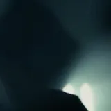 Dark silhouette footage of a live drum set at 0:15