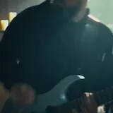 Musician performs live in candlelit church at 0:16