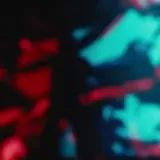 Concert stage lights over silhouetted performer at 0:07