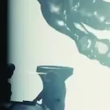 Concert stage lights over silhouetted performer at 0:21