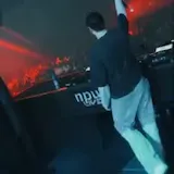 DJ performs on stage with text overlay at 0:07