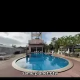 Slum drone shots cut against luxury pool at 0:13