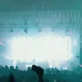 Aerial festival stage lights and crowd at night at 0:01
