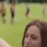 Olive and Adam film scenes in park at 0:06