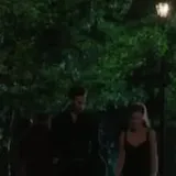 Couple walks at night then embrace at 0:01