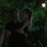 Couple walks at night then embrace at 0:13
