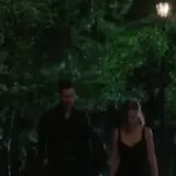 Couple walks at night then embrace at 0:04