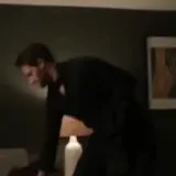 Film couple dancing in dim living room at 0:17