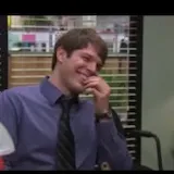 Office coworkers smiling and laughing in scene at 0:06