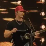 Parker McCollum live singing with guitar at 0:09