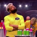 Contestants stack cans with rulers on 99 to Beat at 0:23