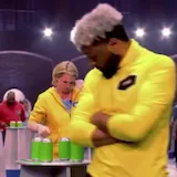 Contestants stack cans with rulers on 99 to Beat at 0:15