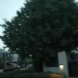 Driving past modern gated houses at dusk at 0:01