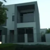 Driving past modern gated houses at dusk at 0:03