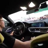 Driver chats while driving his BMW at 0:08