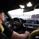 Driver chats while driving his BMW at 0:13