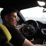 Driver chats while driving his BMW at 0:04