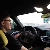 Driver chats while driving his BMW at 0:01
