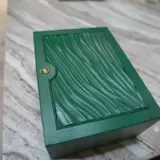 Slow pan over green box on marble at 0:01