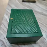 Slow pan over green box on marble at 0:02
