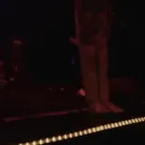 Band performing live on a concert stage at 0:07