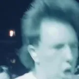 Black-and-white live band crowd footage at 0:06