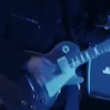Black-and-white live band crowd footage at 0:10