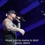 Live concert performance with lyric captions at 0:20