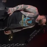 Live concert performance of tattooed singer at 0:37
