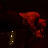 Live concert performance of tattooed singer at 0:07