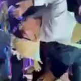 Party crowd dancing in dim club lighting at 0:01