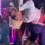 Party crowd dancing in dim club lighting at 0:55
