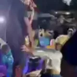 Party crowd dancing in dim club lighting at 0:27