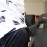 Streamer reacts with shock in gaming chair at 0:12