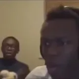 KSI reacts on webcam with friend behind at 0:01