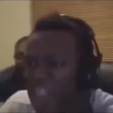 KSI reacts on webcam with friend behind at 0:05