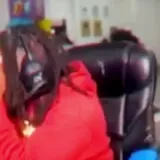 Kai Cenat reacting in gaming chair on stream at 0:04