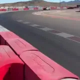 Supercars cornering at Speed Vegas track at 0:01