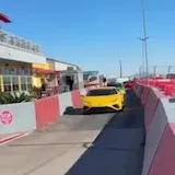Exotic cars pass on Speed Vegas lane at 0:12