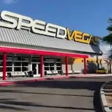 Handheld pan of SPEED VEGAS building exterior at 0:03