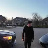 Man walks past mansion and supercars at 0:10