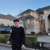 Man walks past mansion and supercars at 0:01