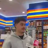 A man buys snacks and shows a Razed win on his phone as his friend says at 0:01