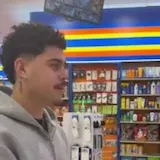 A man buys snacks and shows a Razed win on his phone as his friend says at 0:07