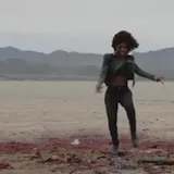 A rapper spits boastful verses over a beat in the CATWOMAN Swamp at 1:14