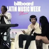 A narrator traces a song from a first proposal to a finished performance at 0:22