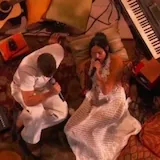 A narrator traces a song from a first proposal to a finished performance at 1:07