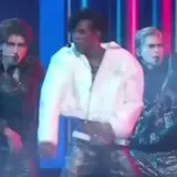 A voice says the performance is in perfect sync with their hit Kawasaki at 1:55